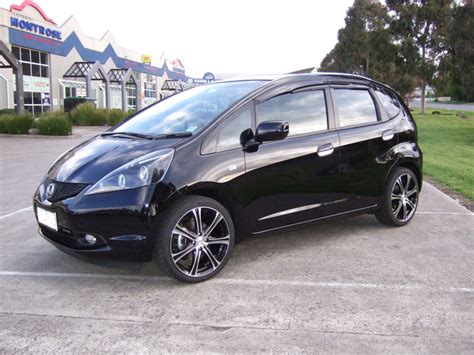 This little car is a blast to drive. . Black honda fit